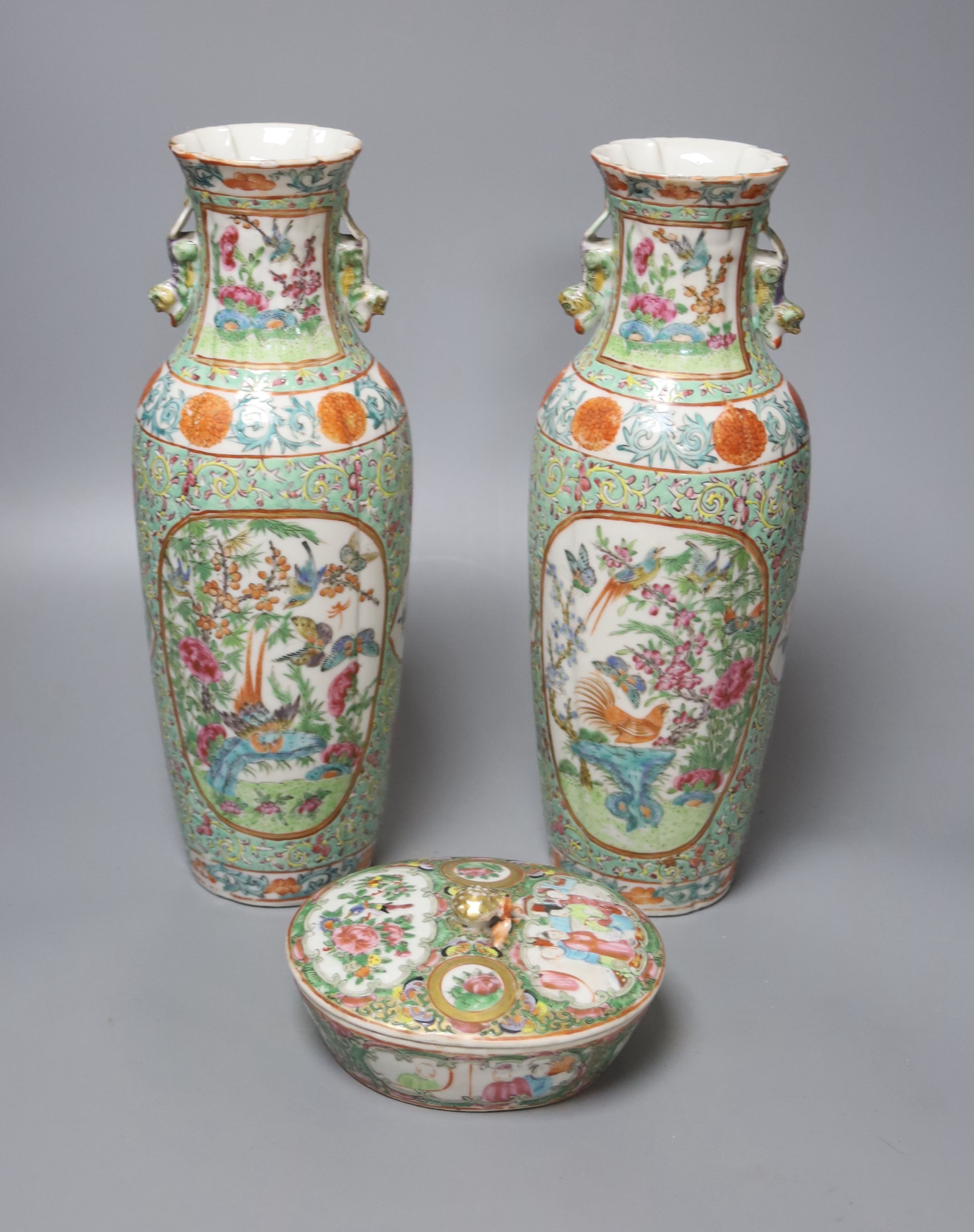 A pair of early 20th century Cantonese export famille rose vases, height 31cm, with a similar box and cover, 4cm diam